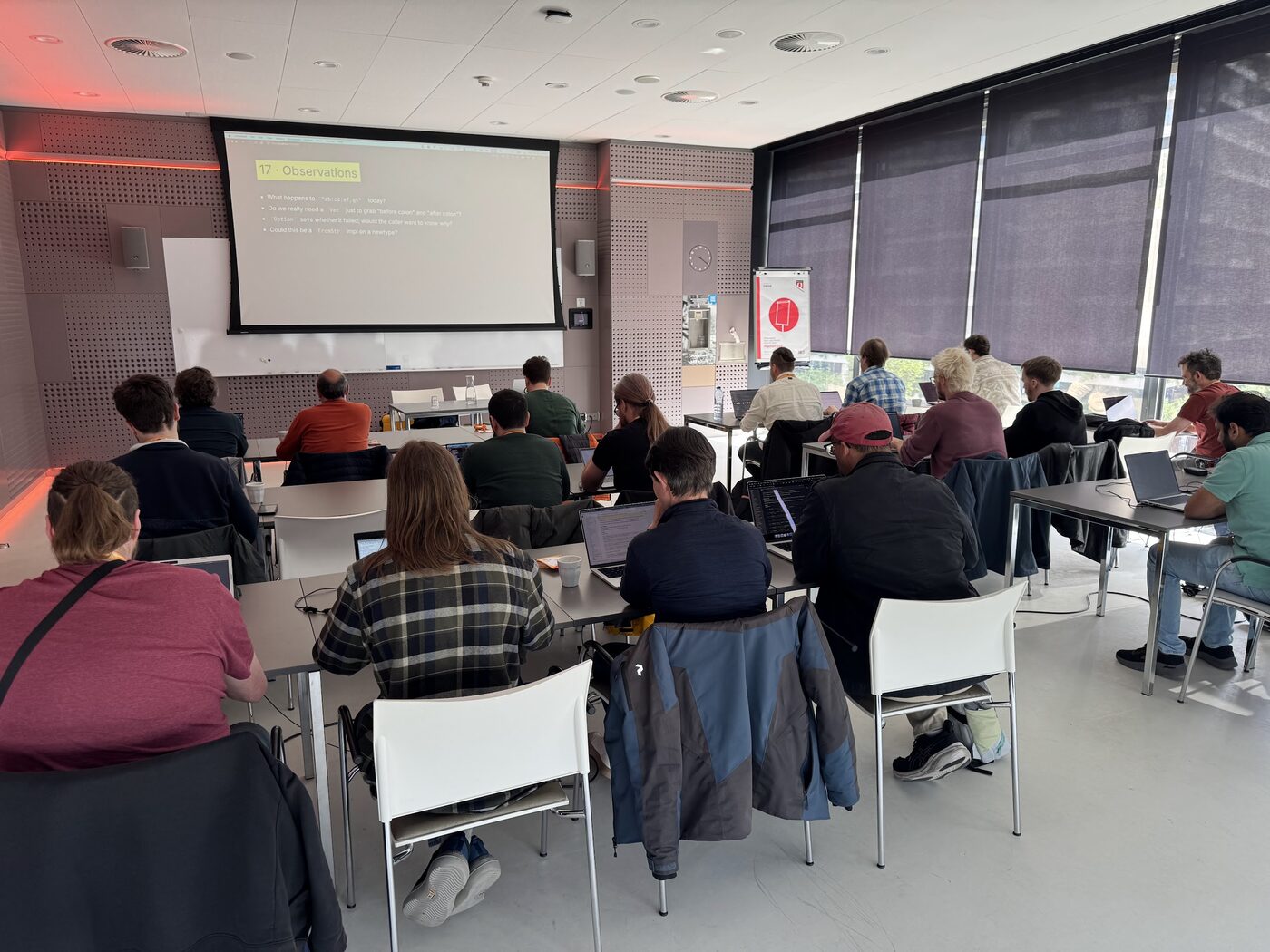 Engineers working through a Rust refactoring workshop in a classroom at Rust Week 2026 in Utrecht